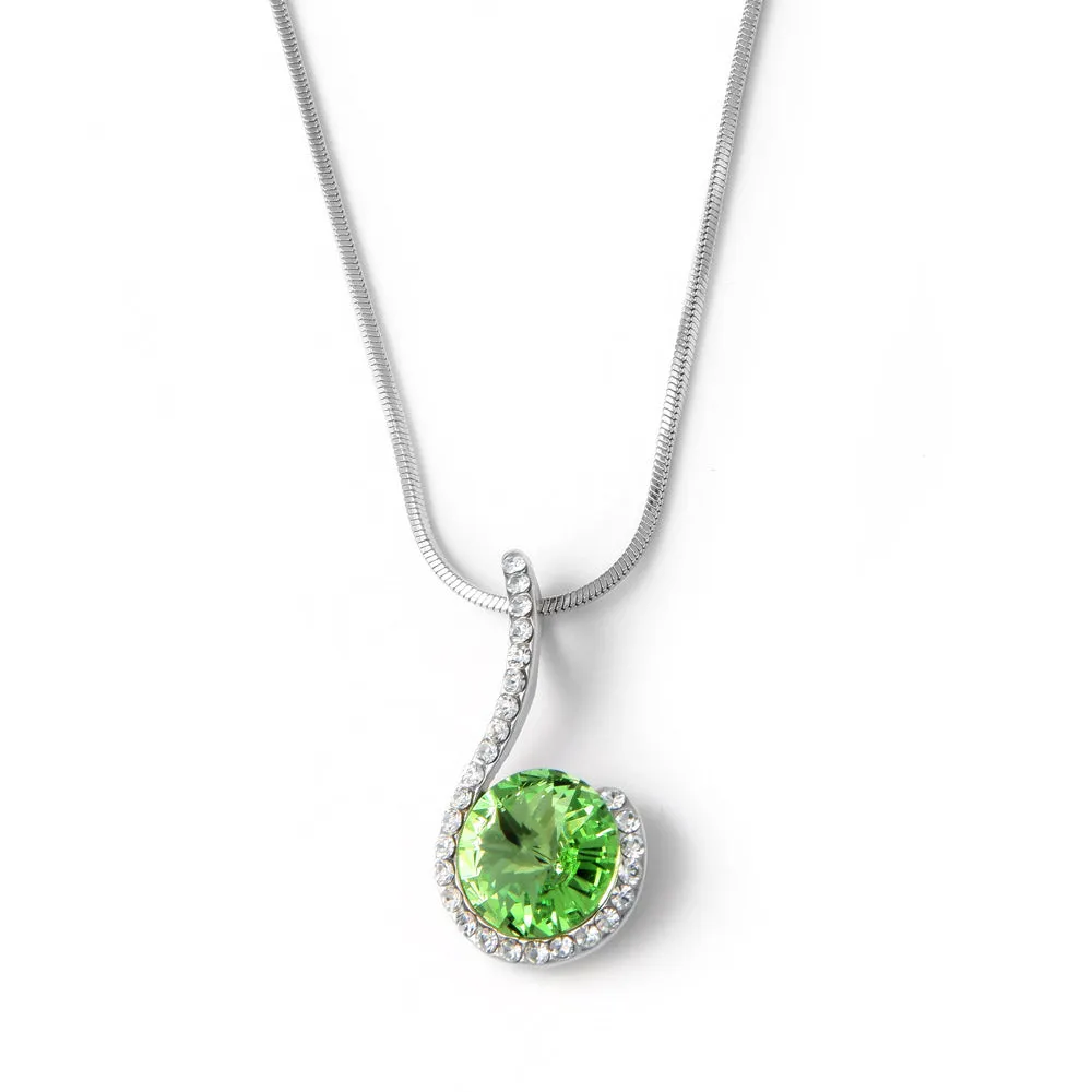 Silver tone pendant with peridot green crystal